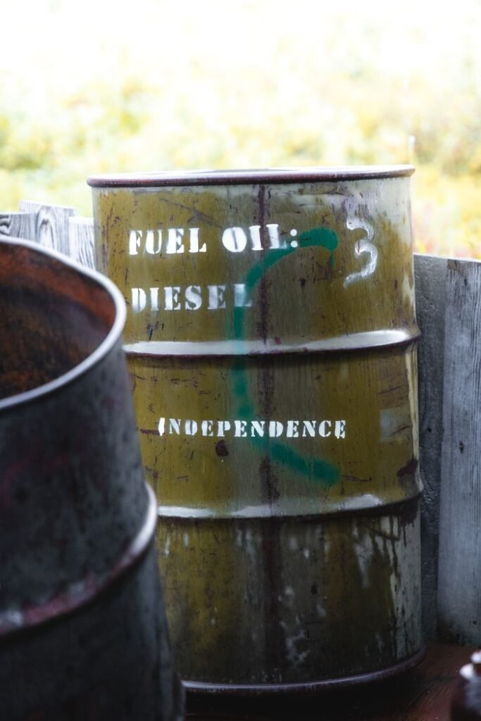 A weathered fuel oil barrel labeled "Diesel" and "Independence" in a rural setting.