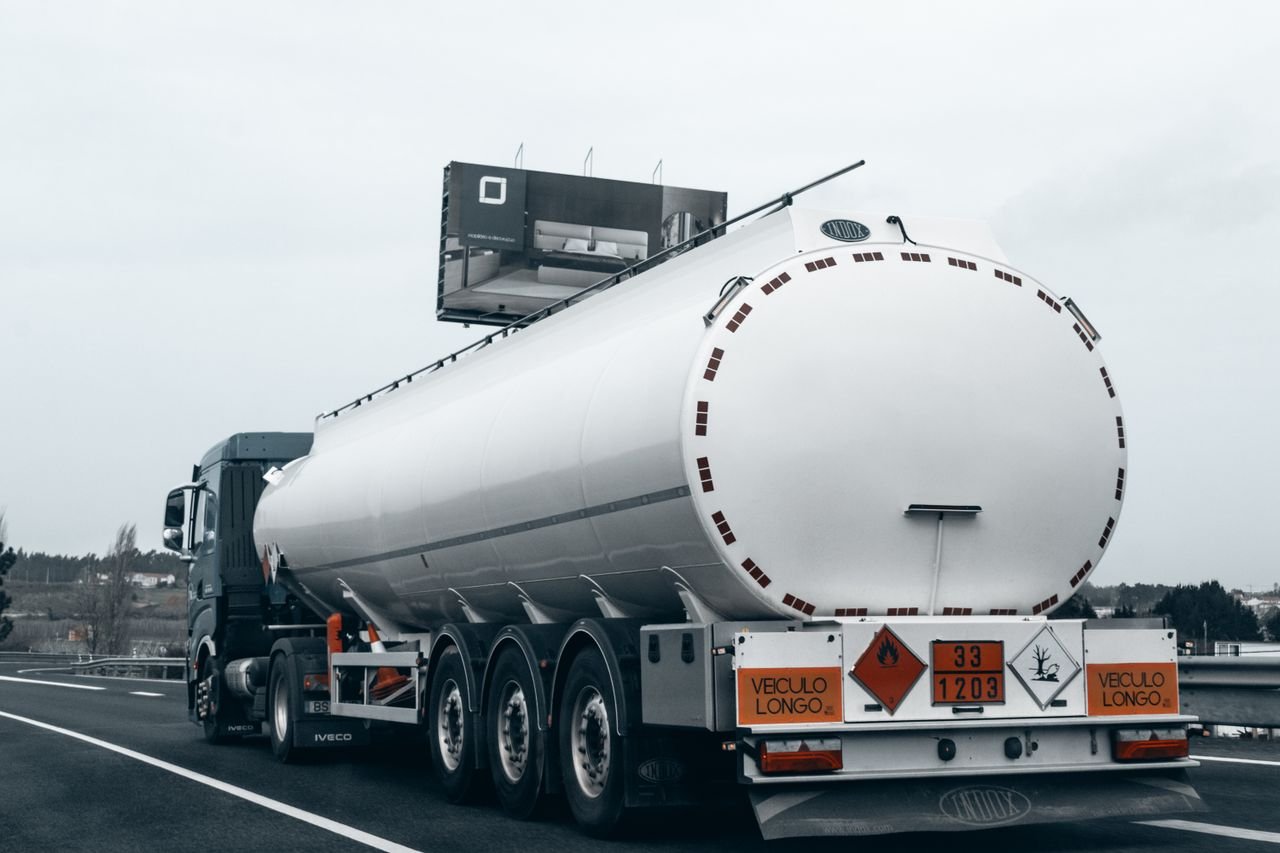 Mastering the First Impression: Your intriguing post title goes here Rear view of a large tanker truck transporting fuel on a highway, emphasizing logistics and transportation.